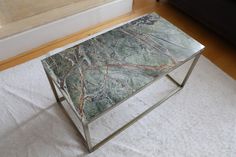 a marble coffee table sitting on top of a white rug