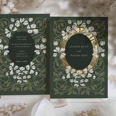 a green and gold wedding card with flowers on the front, in an ornate frame