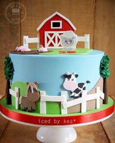 a cake decorated with farm animals on it