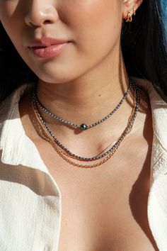 "Focusing on a single shimmering Tahitian pearl, this jewel toned peacock pearl necklace is a handmade Hawaiian treasure. It acts as a phenomenal portrayal of our tranquil mindful island living. ✦ DETAILS ✦ ✧ Name: Kaimalie (KAEE ma LEE eh) - Calm sea, quiet sea. ✧ Adjustable Length from: 14.5\"-16\". ✧ 1 8-10mm Genuine Tahitian Pearl AA-AAA Quality; tone and shape varies. ✧ 2-3mm Peacock Freshwater Pearls. ✧ 14kt Gold Filled Components, Extender, and Clasp. ✧ All Ke Aloha Jewelry pieces come pa Single Strand Tahitian Pearl Jewelry With Round Beads, Tahitian Pearl Drop Jewelry With Round Beads, Tahitian Pearl Chain Necklace With Round Beads, Tahitian Pearl Chain Necklace, Hawaii Necklace, Peacock Pearls, Calm Sea, Peacock Pearl, Gemstone Hoop Earrings