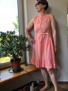 Vintage 90s summer dress. Sleeveless peach pink sun dress with stand up collar. Waist up buttoned dress with side pockets. Gauze cotton dress. M size. From shoulder to shoulder  14,5" 37cm Bust  37"  94cm Waist  40"  102cm Length  40" 102cm. 100% cotton. Sleeveless Peach Cotton Dress, Peach Sleeveless Cotton Dress, Pink Sleeveless Summer Dress For Daywear, Pink Cotton Sleeveless Summer Dress, Pink Sundress Sleeveless For Daywear, Pink Sleeveless Sundress For Daywear, Casual Peach Sleeveless Sundress, Vintage Sleeveless Sundress For Daywear, 90s Summer Dress