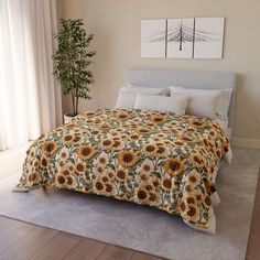 a bed with sunflowers on it in a bedroom next to a plant and window