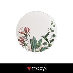 a white plate with flowers and leaves painted on it