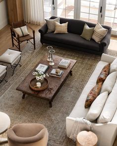 a living room filled with furniture and lots of windows