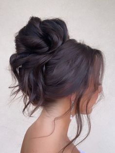 a woman with her hair in a low bun