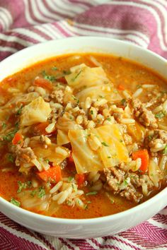 a white bowl filled with meat and vegetable soup