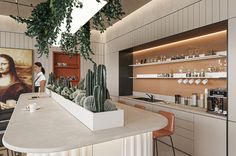 a woman is standing at the counter in a kitchen with cactuses and other items