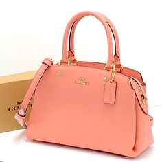 Coach Mini Lillie Carryall Gold/Candy Pink Crossgrain Leather Center Zip Compartment Snap Closure, Fabric Lining Handles With 4 1/4" Drop Outside Open Pocket Detachable Strap With 21 1/2" Drop For Shoulder Or Crossbody Wear Four Protective Feet At Base 10 1/4" (L) 6 3/4" (H) 4 1/4" (W) Style No. 91146 Coach Editor's Notes Our Crossgrain Leather Mini Lillie Carryall Is A Structured Go-Anywhere Bag Featuring Top Handles And A Detachable Strap For Everyday Versatility. Gold Candy, Vintage Leather Handbag, Coach Crossbody Purse, Brown Leather Crossbody Bag, Leather Duffle Bag, Base 10, Leather Duffle, Coach Shoulder Bag, Coach Crossbody Bag