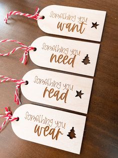 three wooden tags that say something you want and spell out the word,'something you need