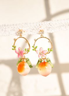 "♥Peach fruit earrings, glass peach drop earrings, crown leaves earrings, food earrings, healing summer earrings, mother's Day, custom  ♥ These adorable earrings are made up of a circle-shaped crown, adorned with leaves and a rose-painted flower. The crown is made of 24-carat gold-plated material. At the end of the loop, there is an orange peach made of Czech crystal, which brings a bright touch of color that reminds us of fruit-laden trees in the summer. On each side of the peach, there is a de Peach Earrings For Summer Gift, Cute Fruit Design Earrings, Bright Earrings, Pink Fruit Design Earrings, Cute Fruit Design Drop Earrings, Peach Clothes, Peach Earrings, Peach Fruit, Fruit Jewelry