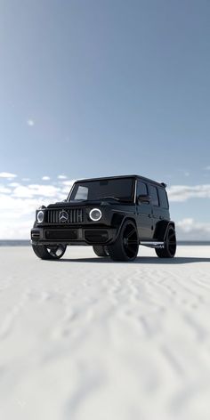 a black jeep is parked in the middle of an empty desert area with blue skies and white clouds