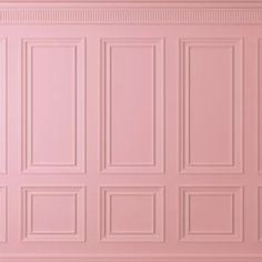 a pink wall with many square and rectangleed panels on the top, in an empty room