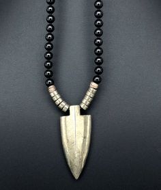 "This necklace was designed for the inner warrior with genuine Black Onyx and Pyrite 6mm beads. A large Pyrite arrow represents strength and power.  This really cool men's necklace is strung on the highest quality stainless steel beading wire for maximum strength and flexibility, then finished with a toggle clasp. Large Pyrite Arrows are approximately 2\" tall x 1 ⅞\" wide at the top. May your day be amazing, Saging Karma® 🦋 More Gemstone Necklaces https://www.etsy.com/shop/SagingKarma?ref=sell Black Hand-strung Amulet Necklace, Black Amulet Necklace, Handmade Black Arrowhead Necklace, Black Hand-strung Amulet Jewelry, Black Warrior Style Jewelry As Gift, Black Warrior Style Jewelry For Gift, Energy Positive, Karma Jewelry, Warrior Necklace