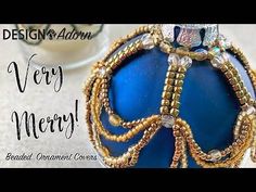 a blue ornament with gold beads on it and the words design & adorn very merry