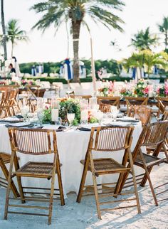 a table set up for an outdoor dinner on the beach