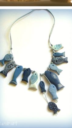 a blue and white necklace with birds on it