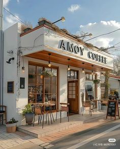 the outside of a coffee shop with tables and chairs