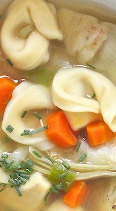 the soup has dumplings and carrots in it, as well as green onions