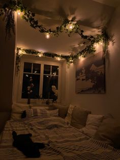 a cat laying on top of a bed under lights