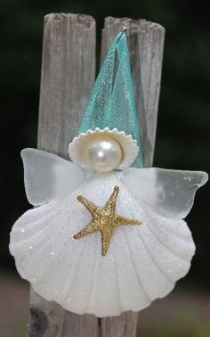 an ornament with a starfish on it and a pearl in the center