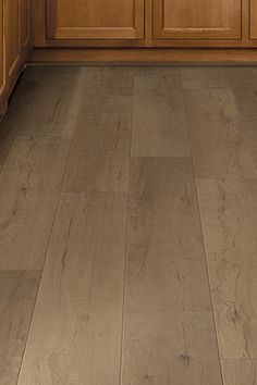 a kitchen with wooden floors and cabinets