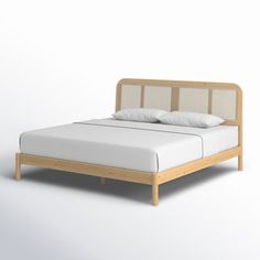 an image of a bed with white sheets and pillows on it's headboard