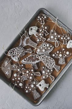 some cookies are decorated with white and brown decorations