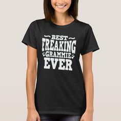 a woman wearing a black t - shirt with the words best freaking grammie ever