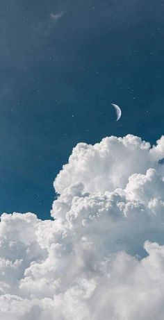 the moon is in the blue sky with white clouds