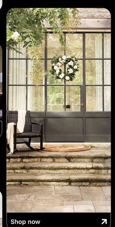 the front door is decorated with flowers and greenery for an elegant touch to any home