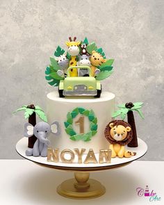 a birthday cake with animals on top