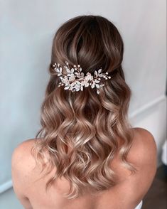 the back of a woman's head wearing a bridal hair comb