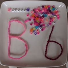 a plate with beads and letters on it