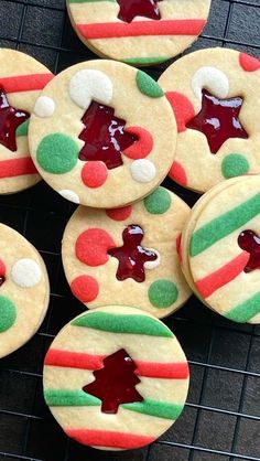 cookies decorated with icing and decorations on a cooling rack