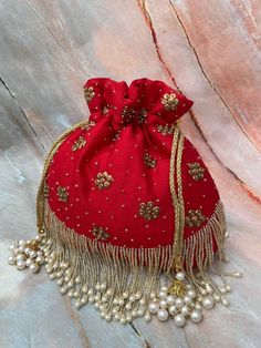 Fabric - velvet  It's beaded potli wid strap Bollywood Style Evening Bag For Diwali, Red Embroidered Party Pouch, Red Embroidered Pouch For Party, Elegant Red Festive Pouch, Embroidered Bags For Party And Festival, Elegant Festival Bags, Traditional Beaded Bag For Party, Evening Bags With Dori Work For Diwali, Red Embroidered Potli Bag For Party