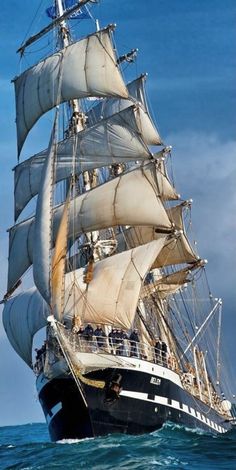 an old sailing ship in the middle of the ocean