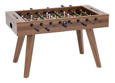 a wooden foosball table with many pieces of game in it