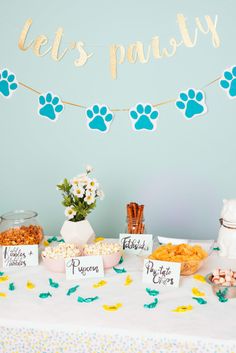 a table topped with lots of food next to a sign that says let's party