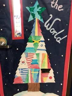 a decorated door with a christmas tree in the center and words on it that say, let the world bake