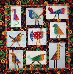 a quilted wall hanging with colorful birds on it