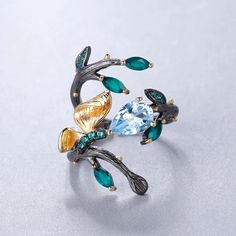 Introducing our "Butterfly's First Flight" Ring—an enchanting piece that captures the delicate beauty of a newly hatched butterfly taking its first flight. This exquisite ring is meticulously crafted from sterling silver and adorned with graceful 18K gold accents. The nano-emerald butterfly perches elegantly on your choice of either Blue Topaz, Garnet, or Amethyst gems for an added touch of radiance. **Product Highlights:** **New Life and Beauty:** - This ring symbolizes the magical moment when Green Blue Topaz Jewelry Gift, Green Blue Topaz Jewelry For Gift, Gift Green Blue Topaz Ring, Butterfly Real, Emerald Butterfly, Emerald Blue, Saint Kitts And Nevis, First Flight, Delicate Beauty