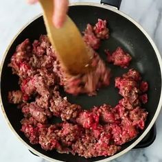 the food is being cooked in the skillet on the stove with a spatula