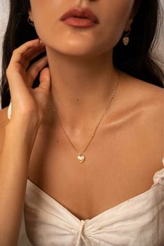 The Lise pearl heart necklace is handcrafted with a heart shaped freshwater pearl and a delicate heart chain. A perfectly classic romantic piece, easy to dress up or down.  14K gold-filled heart chain Heart-shaped freshwater pearl Hypoallergenic, suitable for even the most sensitive skin Each piece is delivered in a silk bag inside a gift box Sustainable packaging   Please note, as we use only natural pearls, shape and size may vary slightly.  We offer a one year guarantee from the date of deliv Elegant 14k Gold Filled Heart Necklace, Gold Dainty Heart Necklace With Pearl Charm, Everyday Gold Feminine Pearl Necklace, Feminine Everyday Gold Pearl Necklace, Elegant White Heart Necklace For Everyday, Everyday Feminine Gold Pearl Necklace, Gold Pearl Necklace For Everyday Feminine Style, Feminine Heart Necklace For Weddings, Feminine Heart Necklace For Wedding