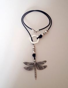 "woman leather, Y necklace, dragonfly pendant necklace, leather woman dragonfly necklace, loop choker, lasso choker, gift idea Check out our \"Bracelet\" and \"Earrings\" for matching pieces ! can I choose different sizes ? Bracelets: Choose from the dropdown menu the length of your wrist. We manufacture the bracelet a little longer for a perfect fit and space to open and close. Necklaces: Choose the desired length from the drop down menu. The pendant of the chain will not be included in length. Handmade Adjustable Metal Lariat Necklace, Adjustable Handmade Metal Lariat Necklace, Elegant Adjustable Dragonfly Necklace, Trendy Jewelry Ideas, Necklace Leather, Dragonfly Necklace, Y Necklace, Dragonfly Pendant, Long Drop Earrings