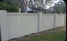 a white fence in front of a house