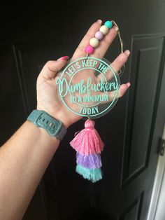 a hand holding a keychain that says, let's keep the dumblockery to a muslim today