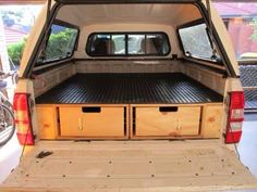 the back end of a white truck with drawers