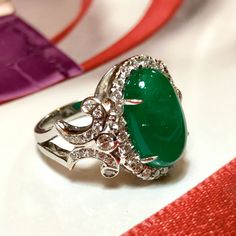 MADE TO ORDER ONLY! 1 week gold crafting period. EXTREMELY VIVID, Certified 7.57 carats, COLOMBIAN Emerald ring. SUGGESTED RETAIL VALUE: $18,000 EMERALD: Weight: 6.63 carats Shape: Oval Cabochon Dimensions: 9.27 x 14.73 x 5.90 mm Color: Green Origin: COLOMBIAN NATURAL EMERALD WITH OIL TREATED ONLY (F3) Gemological certificate provided as shown. TRANSPARENT EXTREMELY CLEAN EXCELLENT COLOR AND CUT! RARE VIVID, COLOMBIAN, BLUISH-GREEN COLOR!! DIAMONDS: 50 round brilliant diamonds weighting a total Luxury Cabochon Diamond Ring For Formal Occasions, Platinum Oval Emerald Ring With 17 Jewels, Oval Platinum Emerald Ring With 17 Jewels, Luxury Formal Cabochon Diamond Ring, Luxury Emerald Ring With Oval Cabochon And 17 Jewels, Luxury Oval Cabochon Emerald Ring With 17 Jewels, Classic Diamond Ring With Cabochon Cut, Classic Diamond Cabochon Ring, Luxury Diamond Cabochons For Wedding