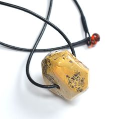 Baltic Amber Large Collectors Item Pendant Natural Baltic Amber Opaque Collectors Item Pendant on leather cord with Amber closure, this Piece has many inclusions and is a very rare unique color of Amber that is not quite often seen, half rough, half polished, some faceting. Inclusions aplenty on this Beauty! Made in Poland. Measures 32X30X20mm. You will receive one Pendant and one 18" Italian Leather Pendant Holder. Arrives to your home with the "All About Amber" Brochure which includes care ins Artisan Jewelry With Leather Strap For Gift, Yellow Leather Jewelry For Gifts, Leather Pendant, Baltic Amber, Leather Cord, Unique Colors, The Collector, Czech Glass, Very Rare