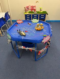 a child's play table with toy cars on it